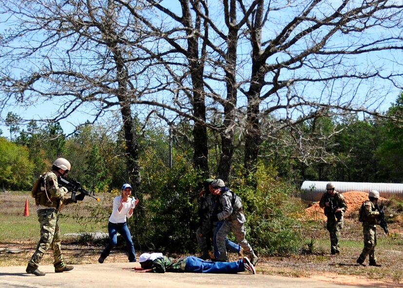 Members of the 919th Security Forces Squadron retrieve a missing American during an extraction exercise at Duke Field, Fla., April 6. The Security Forces Airmen executed this training exercise with the trainees from the Development and Training Program. The DTP is an Air Force Reserve Command introductory program to help recruits prepare for military life prior to going to basic military training. The trainees were given a first-hand view of the procedures performed to recover American personnel from a downed aircraft in a hostile environment. They were able to participate as local nationals and the missing American personnel. (U.S. Air Force photo/Tech. Sgt. Cheryl L. Foster)