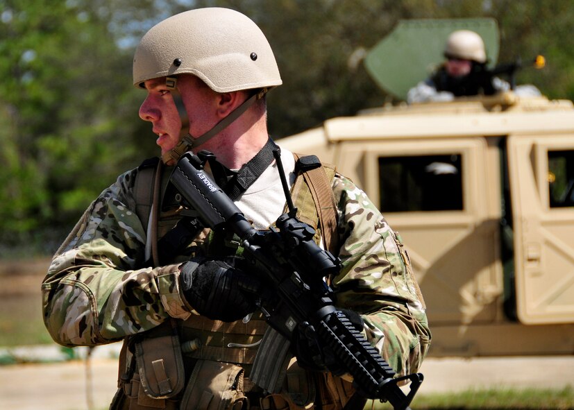 Senior Airman Aaron Bradley, of the 919th Security Forces Squadron, guards the perimeter of a HMMWV during an extraction exercise at Duke Field, Fla., April 6. The Security Forces Airmen executed this training exercise with the trainees from the Development and Training Program. The DTP is an Air Force Reserve Command introductory program to help recruits prepare for military life prior to going to basic military training. The trainees were given a first-hand view of the procedures performed to recover American personnel from a downed aircraft in a hostile environment. (U.S. Air Force photo/Tech. Sgt. Cheryl L. Foster)