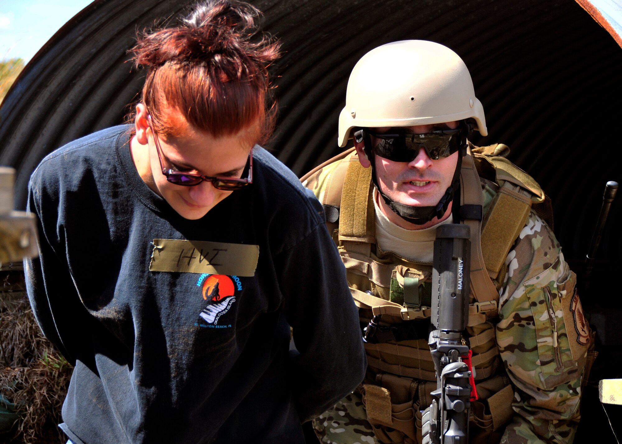 Staff Sgt. Thomas Maloney, of the 919th Security Forces Squadron, escorts Trainee Dawn Hoalt, of the Development and Training Program, to safety during an extraction exercise at Duke Field, Fla., April 6. The Security Forces Airmen executed this training exercise with the trainees from the Development and Training Program. The DTP is an Air Force Reserve Command introductory program to help recruits prepare for military life prior to going to basic military training. The trainees were given a first-hand view of the procedures performed to recover American personnel from a downed aircraft in a hostile environment. They were able to participate as local nationals and the missing American personnel. (U.S. Air Force photo/Tech. Sgt. Cheryl L. Foster)