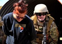 Staff Sgt. Thomas Maloney, of the 919th Security Forces Squadron, escorts Trainee Dawn Hoalt, of the Development and Training Program, to safety during an extraction exercise at Duke Field, Fla., April 6. The Security Forces Airmen executed this training exercise with the trainees from the Development and Training Program. The DTP is an Air Force Reserve Command introductory program to help recruits prepare for military life prior to going to basic military training. The trainees were given a first-hand view of the procedures performed to recover American personnel from a downed aircraft in a hostile environment. They were able to participate as local nationals and the missing American personnel. (U.S. Air Force photo/Tech. Sgt. Cheryl L. Foster)