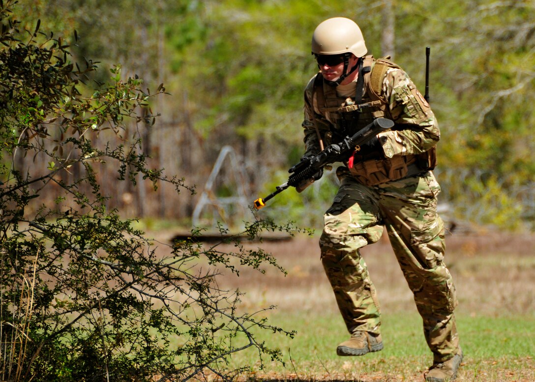 Staff Sgt. Thomas Maloney, of the 919th Security Forces Squadron, runs for cover during an extraction exercise at Duke Field, Fla., April 6. The Security Forces Airmen executed this training exercise with the trainees from the Development and Training Program. The DTP is an Air Force Reserve Command introductory program to help recruits prepare for military life prior to going to basic military training. The trainees were given a first-hand view of the procedures performed to recover American personnel from a downed aircraft in a hostile environment. (U.S. Air Force photo/Tech. Sgt. Cheryl L. Foster)