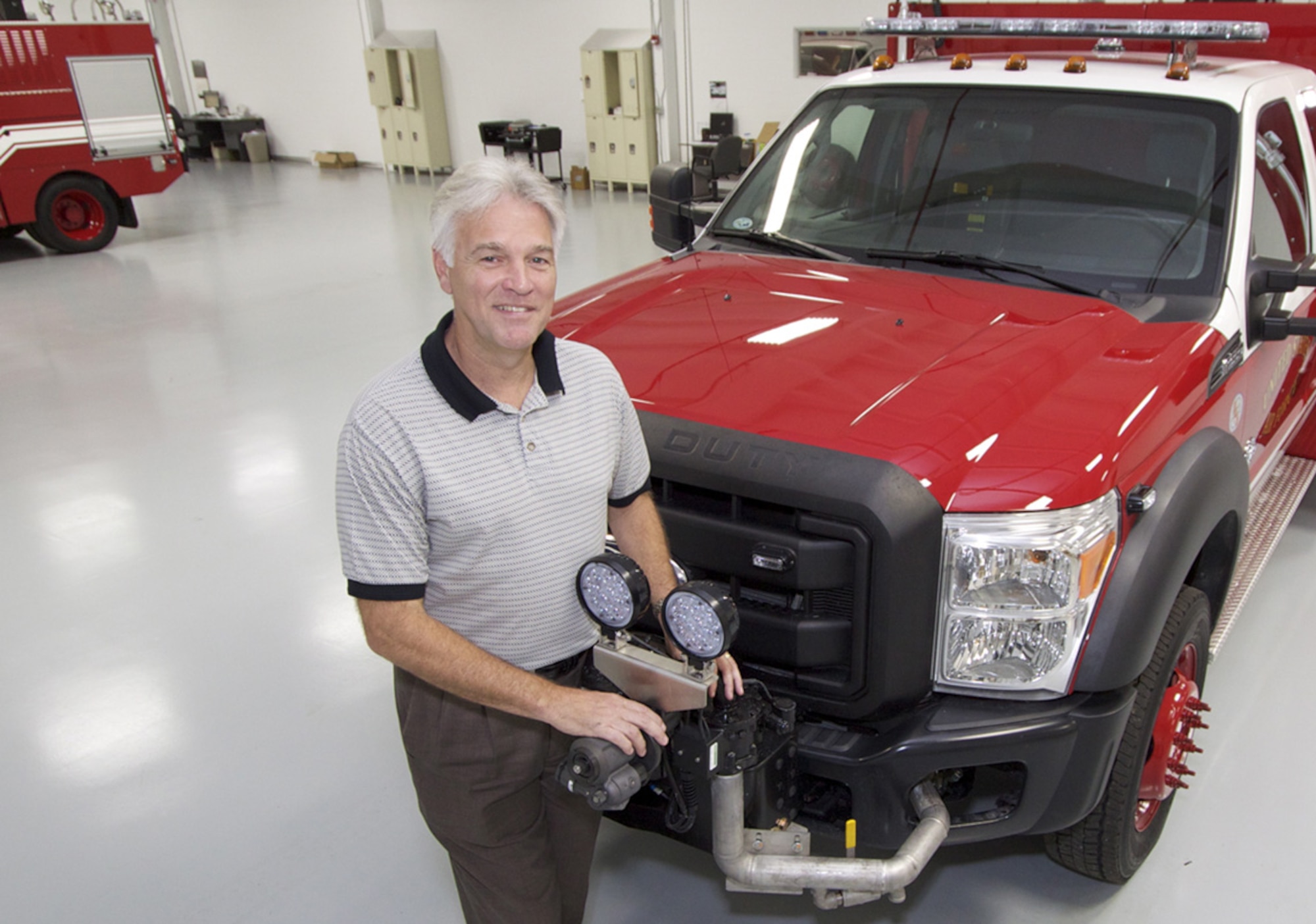 TYNDALL AIR FORCE BASE, Fla. -- The new Air Force Fire Chief Jim Podolske poses with a fire services vehicle here recently. The Air Force named Podolske as chief of the Fire Emergency Services, a division of the Air Force Civil Engineer Center’s Readiness Directorate April 8, 2013. As the Air Force Fire Chief, Podolske manages a force of more than 9,200 military and civilian firefighters as well as the programs that provide them with equipment, vehicles and training. (U.S. Air Force photo/Eddie Green)