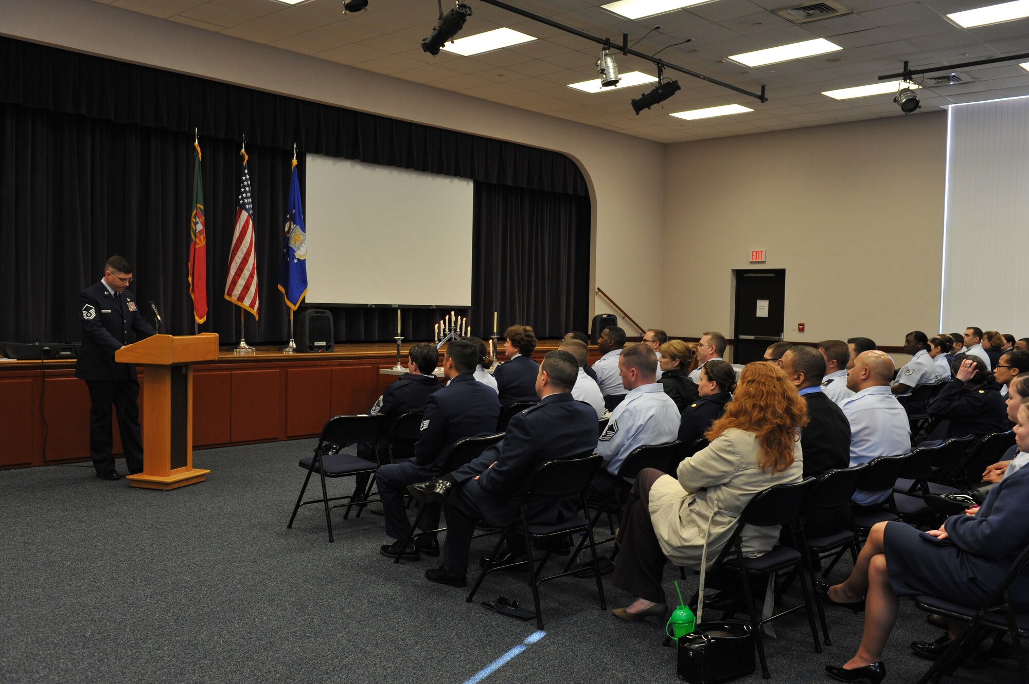 Master Sgt. William Church, 65th Logistics Readiness Squadron and event keynote speaker, speaks during a formal ceremony commemorating the Holocaust at Lajes Field, April 8.  The 65th Air Base Wing remembered the Holocaust, honored the victims' memory and focused on how Airmen stand against genocide and atrocities.  The event included a name-reading and candle-light vigil held in conjunction with the National Holocaust Days of Remembrance. This year's national theme is "Never Again - Heeding the Warning Signs."  (Photo by Guido Melo)     