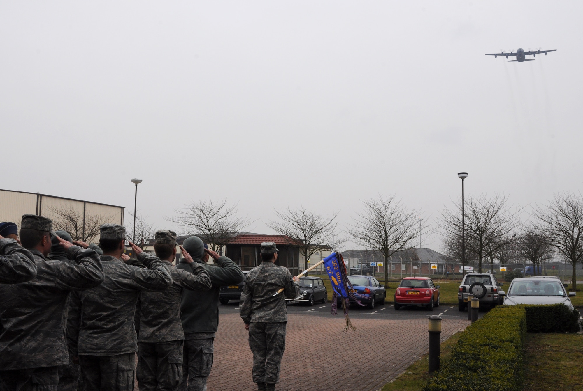Airmen of the 67th Special Operations Squadron give a final salute to MC-130P Combat Shadow 65-0992 as it makes its final flight over RAF Mildenhall, England, March 8, 2013, en route to Davis-Monthan Air Force Base, Ariz., where it is being retired after 47 years of rescue, humanitarian and special operations service. This occasion officially marks the beginning of Special Operation Command Europe's transition from the Combat Shadow to new aircraft. (U.S. Air Force photo by Staff Sgt. Thomas Trower/Released)