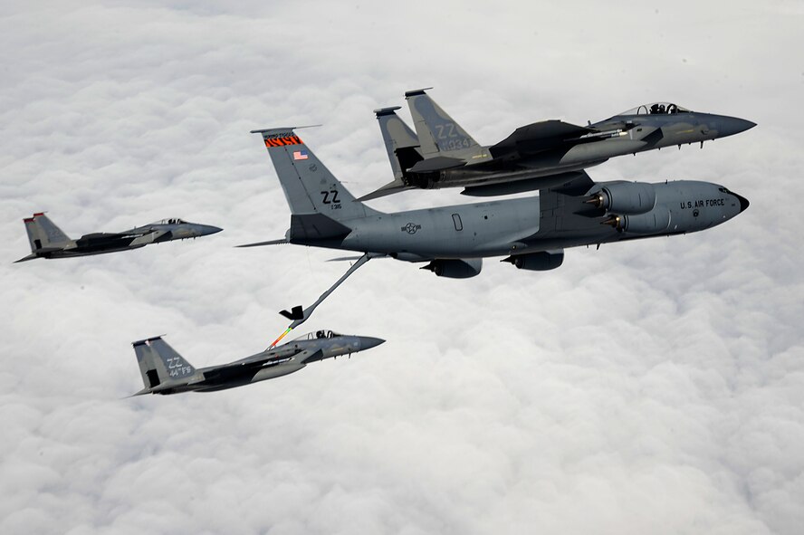 A U.S. Air Force KC-135 Stratotanker aerial refueling aircraft from the 909th Air Refueling Squadron refuels a 44th Fighter Squadron F-15 Eagle while two other F-15s fly in formation during a training mission over Okinawa, Japan, April 5, 2013. The KC-135 and F-15 are two of five aircraft regularly operated from Kadena Air Base. (U.S. Air Force photo/Senior Airman Maeson L. Elleman)