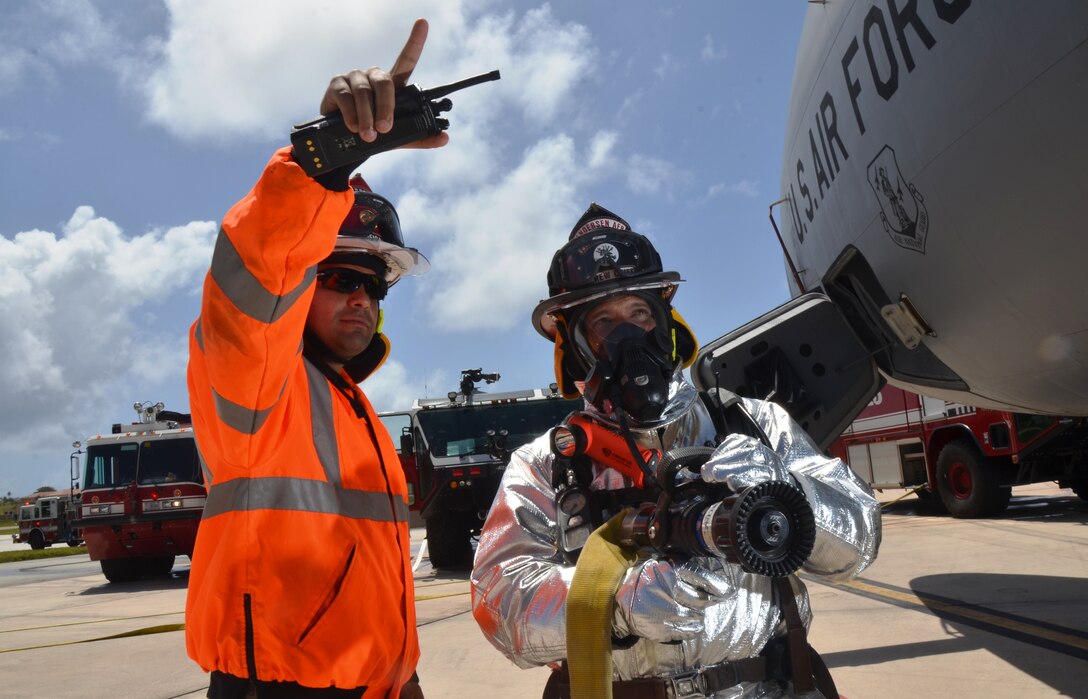 Master Sgt. Essam Cordova, 36th Civil Engineer Squadron Fire and Emergency Services assistant chief of operations during 2012, stands with Tech. Sgt. Arnold Castro, 36th CES Fire and Emergency Services station captain, during an aircraft fire training exercise on Andersen Air Force Base, Guam, April, 4, 2013. Castro was awarded the Navy Fire and Emergency Services Military Firefighter of the Year and Cordova was awarded Navy Fire and Emergency Services Military Fire Officer of the Year.  (U.S. Air Force photo by Staff Sgt. Veronica McMahon/Released)