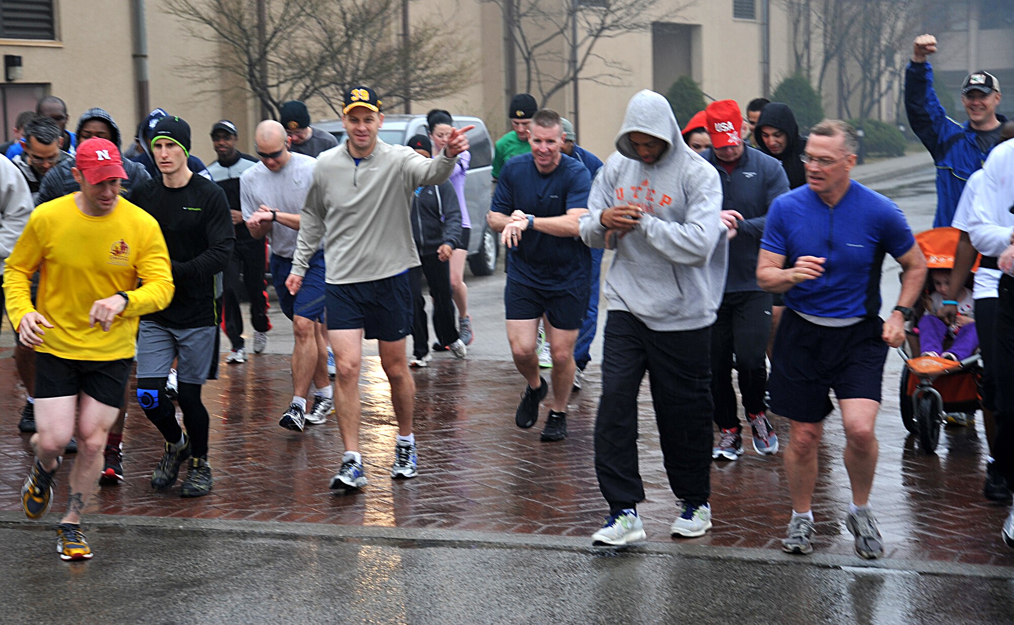 Runners participating in the Sexual Assault Awareness Month 5K run have a rainy start at Osan Air Base, Republic of Korea, April 6, 2013.  The SAAM 5K was a free event hosted to spread sexual assault awareness for the month of April, the event was held rain or shine.  (U.S. Air Force photo/Staff Sgt. Emerson Nuñez)
