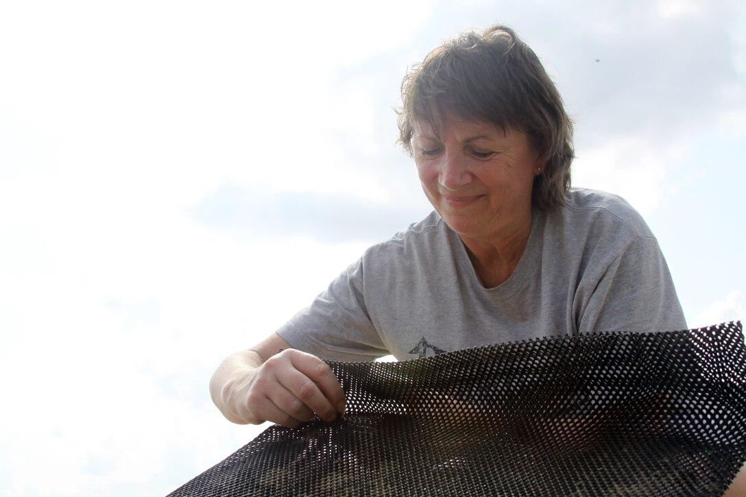 FORT NORFOLK, Va. -- Geographer Karin Dridge from the Norfolk District, U.S. Army Corps of Engineers, assembles a mesh bag for the baby oysters, or spat.