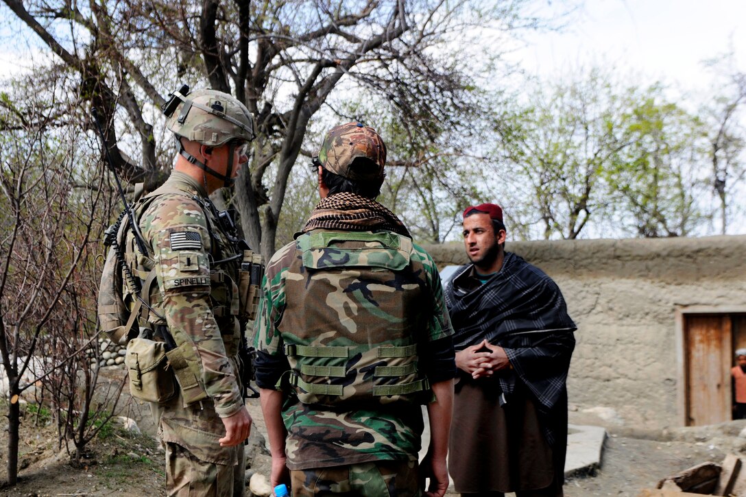 U.S. Army 1st Lt. Josiah Spinelli, left, talks with a local Afghan ...