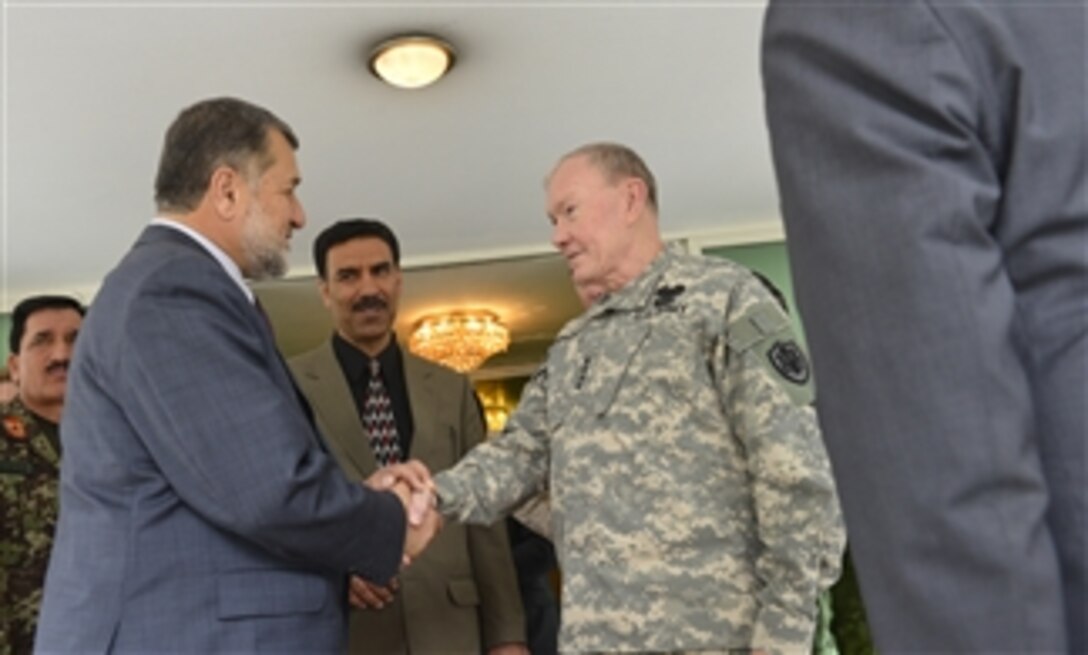 Afghanistan’s Minister of Defense Bismullah Muhammadi Khan, left, shakes hands with Chairman of the Joint Chiefs of Staff Gen. Martin E. Dempsey during their meeting in Bagram, Afghanistan, on April 6, 2013.  Dempsey is meeting with deployed service members, coalition leaders and Afghan leaders to assess the progress of the transition to an Afghan-secured Afghanistan.  