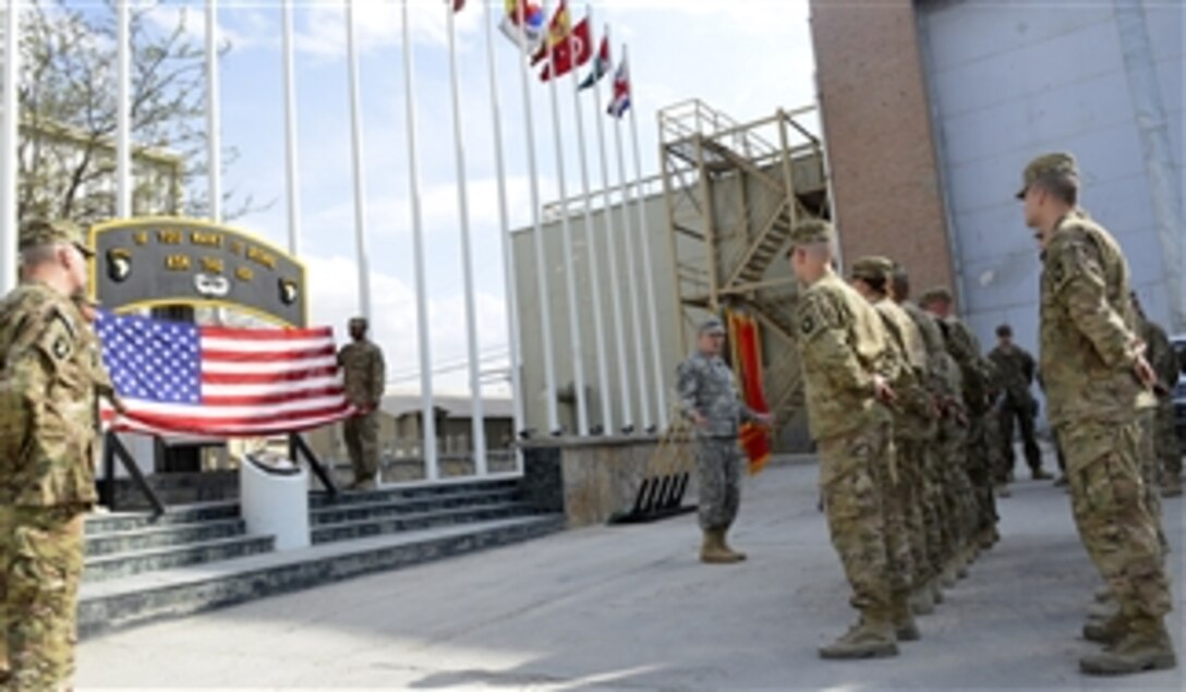 Chairman of the Joint Chiefs of Staff Gen. Martin E. Dempsey, right, talks with service members before a re-enlistment ceremony in Bagram, Afghanistan, on April 7, 2013.  Dempsey is meeting with deployed service members, coalition leaders and Afghan leaders to assess the progress of the transition to an Afghan-secured Afghanistan.  