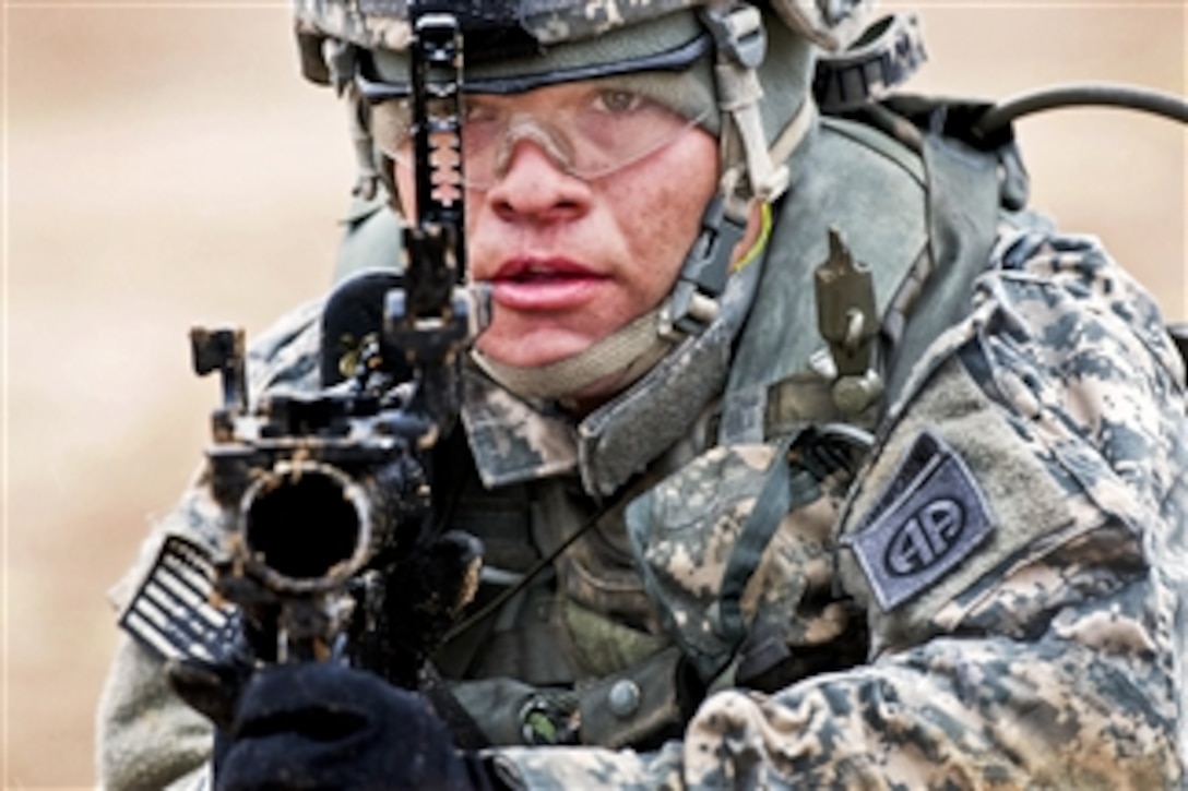 U.S. Army Spc. Travis Williams, a grenadier with the 82nd Airborne Division’s 1st Brigade Combat Team, looks through the sights of his M320 grenade launcher at Fort Bragg, N.C., on March 24, 2013.  Williams and his team are providing support by fire for another element that is assaulting an objective during training.  