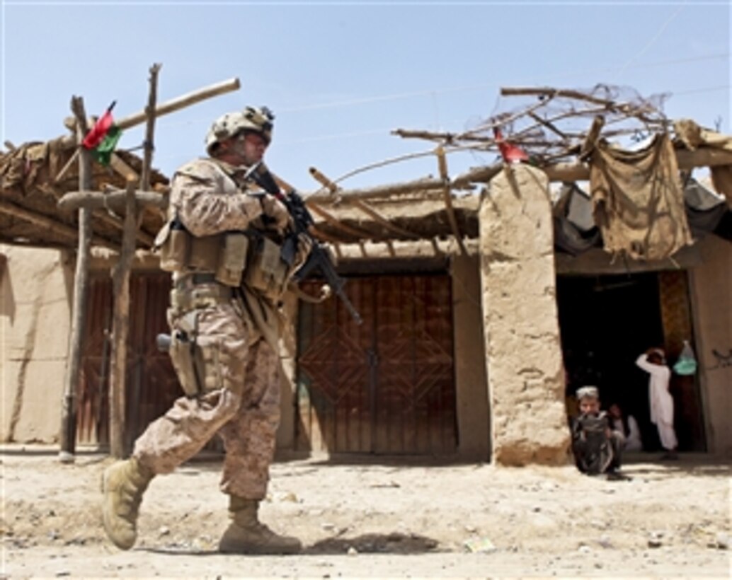 U.S. Marine Corps Sgt. Benito Serrano patrols through the bazaar near Outpost Mamuriyet in the Kajaki district of the Helmand province of Afghanistan, on April 1, 2013.  Serrano is assigned to the Marine Corps-led Kajaki Police Mentor Team.  The mentor team visited the outpost and patrolled with the police through the bazaar.  