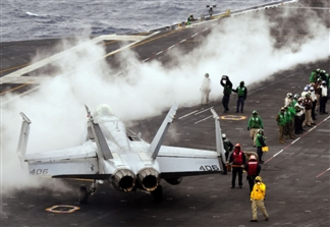 Flight deck crewmen prepare to launch an F/A-18C Hornet from the flight deck of the aircraft carrier USS Nimitz (CVN 68) on April 6, 2013.  Nimitz is underway for a sustainment training exercise in preparation for an upcoming deployment.  The Hornet is assigned to Marine Fighter Attack Squadron 323.  