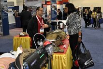 Mark Urrutic of Family of Field Medical Equipment answers a question asked by a visitor April 8 during the Sea-Air-Space Exposition at the Gaylord National Convention Center in National Harbor, Md. 