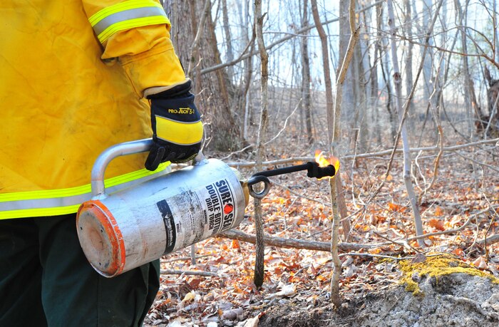 Quantico Fire Department and Emergency Rescue Services responded to a fire crawling through the woods in Training Area 11 on the west side of Marine Corps Base Quantico on April 9, 2013. The affected area was too large to extinguish outright so emergency responders limited the spread of the fire by bulldozing a "no burn" zone around it. After the zone had been crafted, firefighters fought fire with fire by "back-burning", a controlled burn designed to rob the fire of fuel so it can be managed safely.