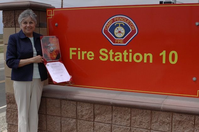 Dorothy Tellez displays a letter from Gen. James F. Amos, commandant of the Marine Corps, which dedicates Pendleton’s Fire Station 10 in honor of Sgt. Brian E. Dunlap here April 6. Dunlap was an advisor for the Iraqi Army and firefighter with the Camp Pendleton Fire Department and in 2005 and was killed by an improvised explosive device while conducting combat operations against enemy forces in Abu Fleiss, Iraq.