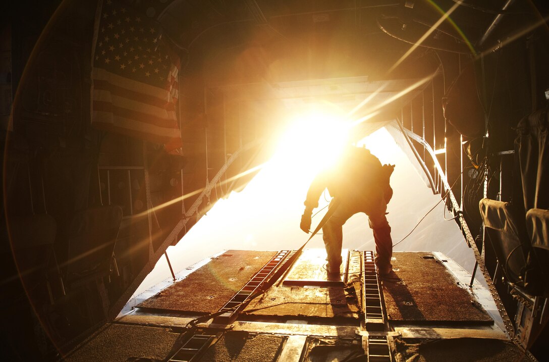 A U.S. Marine CH-56E Super Stallion crew chief assigned to Marine Heavy Helicopter Squadron (HMH) 361, Marine Aircraft Group 16, 3rd Marine Aircraft Wing (Forward), makes his way to the ramp while flying over Helmand province, Afghanistan, Nov. 13, 2012. HMH-361 is deployed in support of Operation Enduring Freedom. (U.S. Marine Corps photo by Cpl. Alejandro Pena)