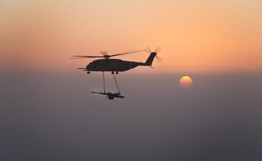 A U.S. Marine Corps CH-53E Super Stallions with Marine Heavy Helicopter Squadron (HMH) 361, Marine Aircraft Group 16, 3rd Marine Aircraft Wing (Forward), externally lifts M777 howitzers over Helmand province, Afghanistan, Dec. 29, 2012. HMH-361 provided aerial support by repositioning the howitzers to Camp Dwyer. 
(U.S. Marine Corps photo by Sgt. Keonaona C. Paulo)