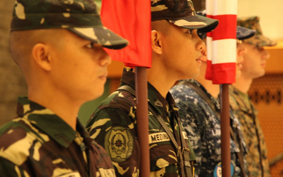 Philippine and U.S. members of the color guard march out the Philippines and U.S. flags during the opening ceremony to exercise Balikatan 2013 April 5 at the Commissioned Officers' Club at Camp Emilio Aguinaldo, Philippines. "Exercise Balikatan is a great opportunity for both countries to work shoulder-to-shoulder," said U.S. Marine Brig. Gen. Richard L. Simcock, II. "Together, we will be able to strengthen our bond and ensure that we are capable to deal with any future issues which may come up in the region." Simcock is the U.S. exercise deputy director. (U.S. Marine Corps photo by Cpl. Courtney G. White/Released)