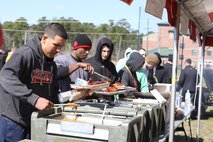 Marines grab a hearty lunch of barbeque, baked beans and chips during their HMLA-167 45th birthday celebration, March 28.