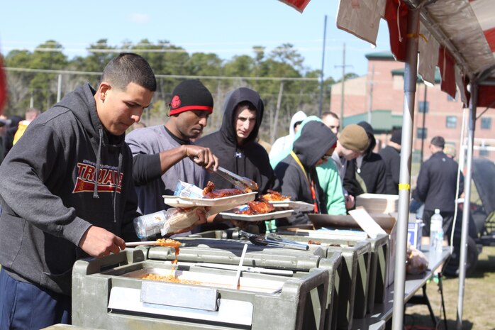 Marines grab a hearty lunch of barbeque, baked beans and chips during their HMLA-167 45th birthday celebration, March 28.
