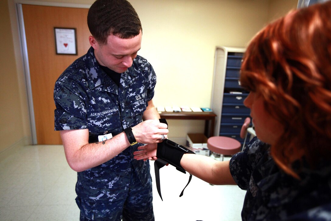 Seaman Dylan T. Adkinszimmerman, a corpsman with Naval Health Clinic Cherry Point, practices putting on a thumb spica, which is used for sprained wrists, at the Naval Health Clinic here April 8. Shortly after arriving here, Adkinszimmerman found himself struggling financially, but a quick assistance loan from the Navy-Marine Corps Relief Society helped him as he adjusted to his first duty station. 