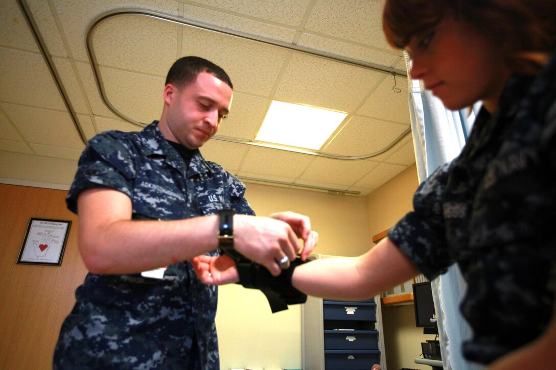 Seaman Dylan T. Adkinszimmerman, a corpsman with Naval Health Clinic Cherry Point, practices putting on a thumb spica, which is used for sprained wrists, at the Naval Health Clinic here April 8. Shortly after arriving here, Adkinszimmerman found himself struggling financially, but a quick assistance loan from the Navy-Marine Corps Relief Society helped him as he adjusted to his first duty station. 
