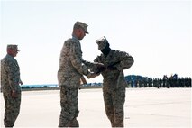 Sgt. Maj. Christopher Edmondson receives the NCO sword from Col. Christopher Seymour, MAG-26 commanding officer, officially accepting the role of the senior enlisted advisor of MAG-26 during a relief and appointment ceremony, March 28.
