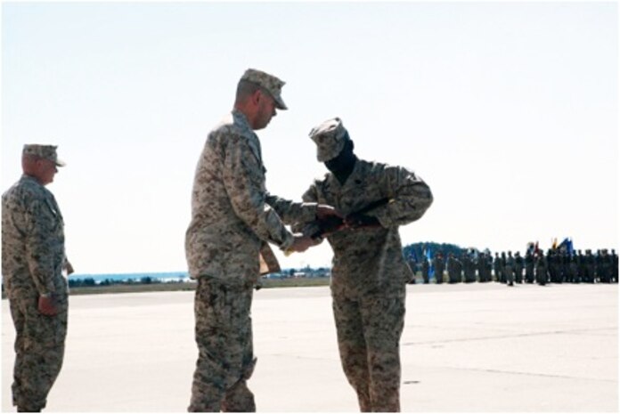 Sgt. Maj. Christopher Edmondson receives the NCO sword from Col. Christopher Seymour, MAG-26 commanding officer, officially accepting the role of the senior enlisted advisor of MAG-26 during a relief and appointment ceremony, March 28.
