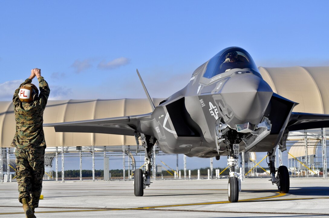 Gunnery Sgt. Matthew Smith, a maintainer with Marine Fighter Attack Squadron 501, marshals in the first Marine variant F-35B Lightning II joint strike fighter to arrive at Eglin Air Force Base, Fla., Jan. 11.