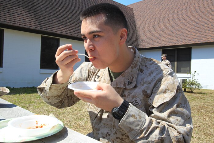 Lance Cpl. Matthew Mahoney eats a bowl of chili to support Headquarters and Headquarters Squadron’s chili cook-off to raise money for the Marine Corps Birthday Ball, March 28. The event raised more than $450 toward the Marine Corps Birthday Ball. (USMC Photo by LCpl Lance Cpl. Manuel A. Estrada)