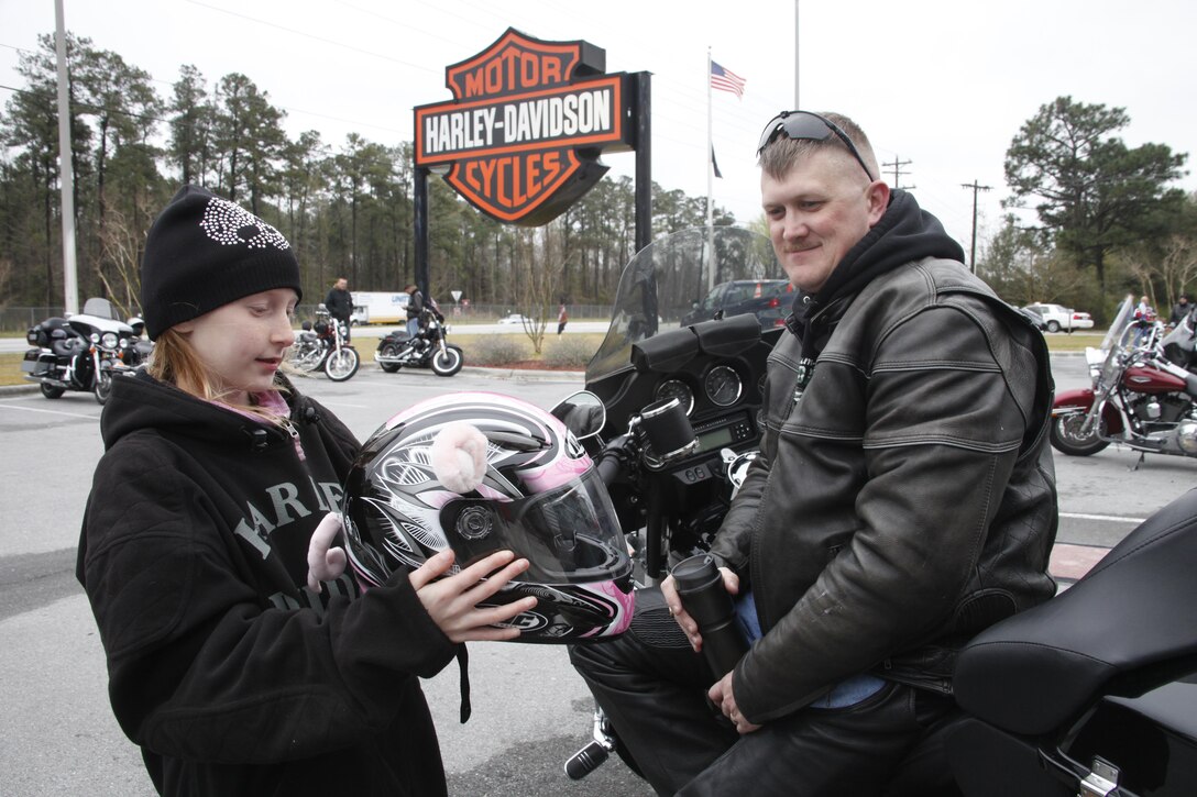 Gunnery Sgt. Eric Smith, the 2nd Marine Division strategic spectrum manager, and his nine-year-old daughter Victoria look over her helmet before departing from the New River Harley-Davidson in Jacksonville, N.C., Friday for a ride in support of Alcohol Awareness Month. Approximately 80 Marines from Cherry Point, Camp Lejeune and New River participated in the ride sponsored by the Coastal Coalition for Substance Abuse Prevention and the traffic safety office aboard Camp Lejeune, N.C.