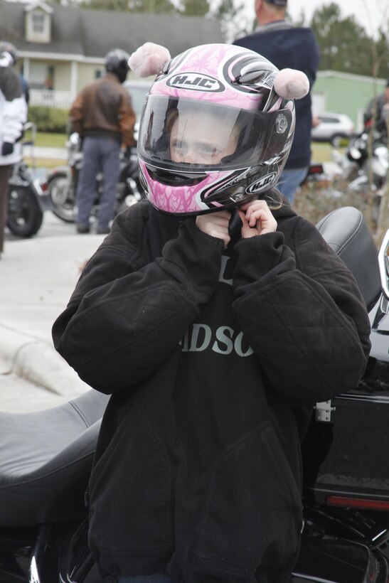 Victoria Smith, daughter of Gunnery Sgt. Eric Smith, the 2nd Marine Division strategic spectrum manager, puts on her helmet before getting on the back of her father’s Harley Davidson at the New River Harley-Davidson dealership Friday, before participating in a motorcycle ride for Alcohol Awareness Month sponsored by the Coastal Coalition for Substance Abuse Prevention and the traffic safety office aboard Camp Lejeune, N.C.

Gunnery Sgt. Smith said he take it personal anytime he loses a friend to an alcohol related incident. He is part of a motorcycle mentorship program because he feels there are many worthwhile activities to get involved in that don’t involve alcohol.
