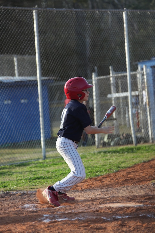 Desmones Eye Care’s second baseman begins to rush out of the batters box after hitting a screaming line drive to left during the Havelock Little League’s season opener April 8. He is a military child whose dad is currently deployed. 