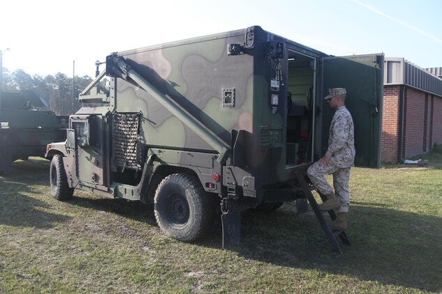 Sgt. Dustin M. Poe, a section leader with 2nd Low Altitude Air Defense Battalion Bravo Battery, watches as a junior Marine gets trained on the Joint Range Extension system that is equipped to a section leader’s vehicle at the battery headquarters April 9. The JRE system is used to send air pictures from the section leader to his fire teams. Air pictures are readouts sent to the leader’s vehicle from satellites, Air Force aircraft and even Marine Corps ground radar systems, and gives the section leaders a better eye on what is in the local area both friendly and enemy.