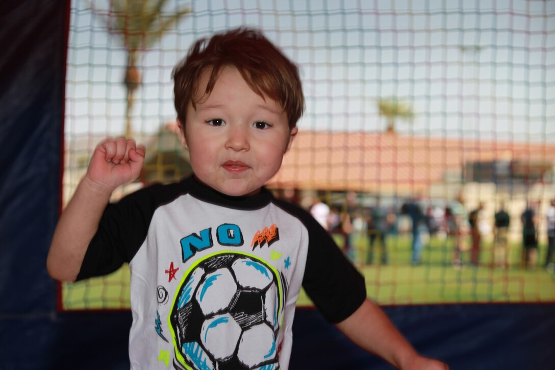 Michael Johnson, 2, son of Lance Cpl. Michael Johnson, rifleman, Company C, 1st Battalion, 7th Marine Regiment, plays in a bouncy-house at 1/7's Family Day held at the Desert Winds Golf Course March 22, 2013. 