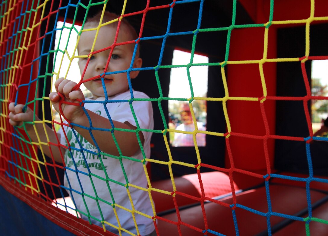 Ethan Scheffer, 2, son of Lance Cpl. Nick Scheffer, mortorman, 1st Battalion, 7th Marine Regiment, plays in a bouncy-house at 1/7's Family Day held at the Desert Winds Golf Course March 22, 2013. 