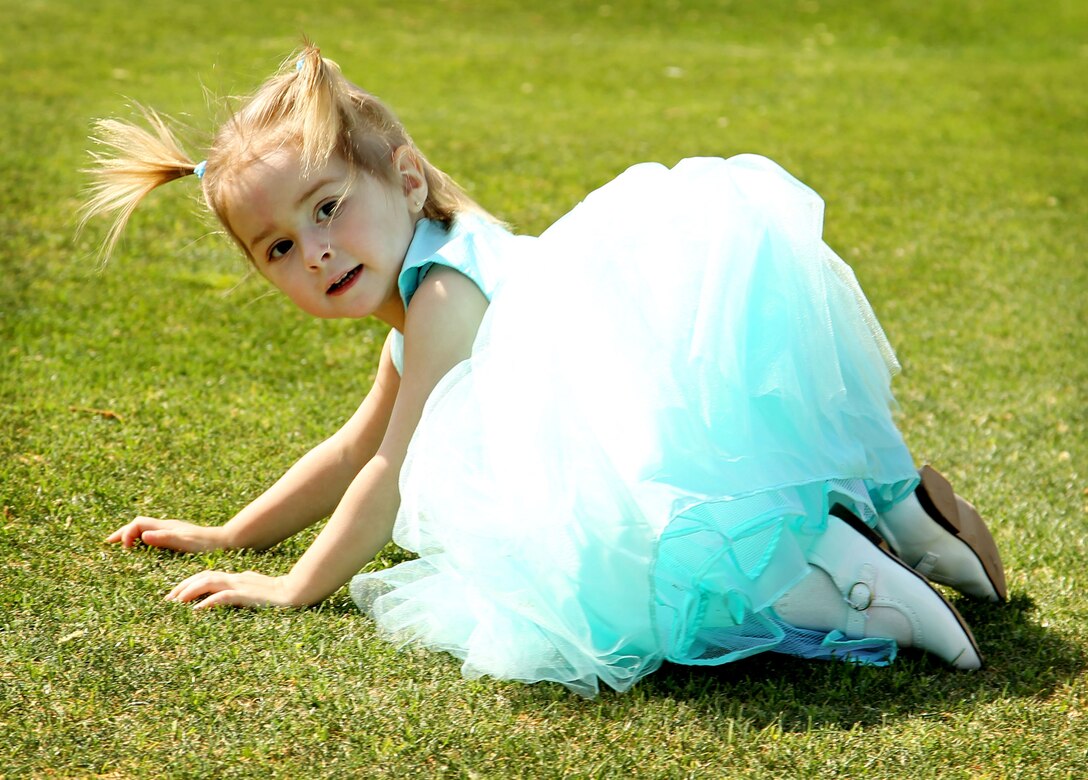 Asa Jones, 2, daughter of Sgt. Luke Jones, section leader, Weapons Company, 1st Battalion, 7th Marine Regiment, plays at 1/7's Family Day held at the Desert Winds Golf Course March 22, 2013. 