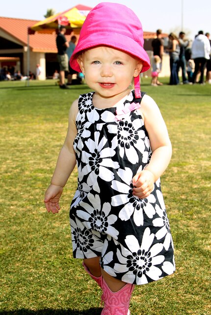 Carly Brandt, 1, daughter of Cpl. Joe Brandt, squad leader, Company A, 1st Battalion, 7th Marine Regiment, collects Easter eggs at 1/7's Family Day held at the Desert Winds Golf Course March 22, 2013. 