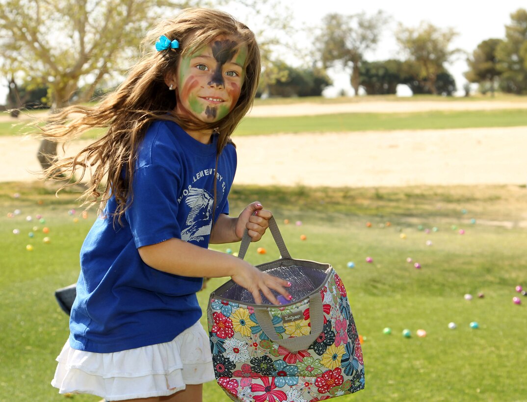 Alisa Avila, 5, daughter of Staff Sgt. Orlando Avila, platoon sergeant, Company B, 1st Battalion, 7th Marine Regiment, collects Easter eggs at 1/7's Family Day held at the Desert Winds Golf Course March 22, 2013. 