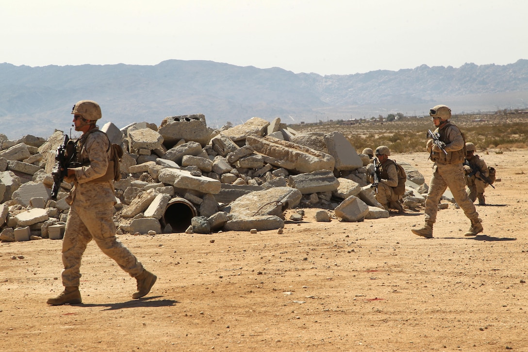 ] Marines with Combat Logistics Battalion 7 patrol during a non-lethal weapons training exercise at the Combat Center’s Range 800 March 21. CLB-7 employed the use of the Active Denial System 2 exercise as part of their training.