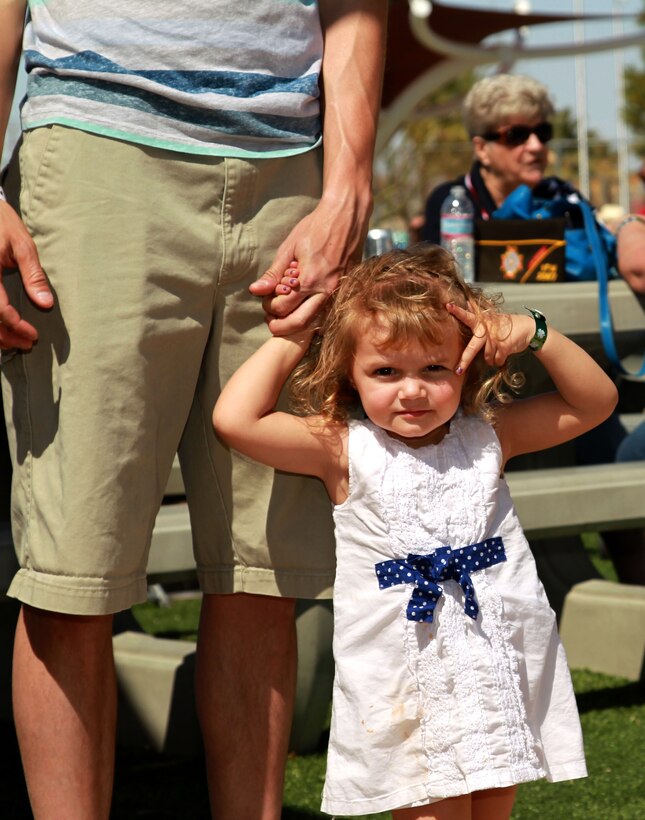 Madison, 2, daughter of Sgt. Chris Jones, unmanned aerial vehicle technician, Marine Unmanned Aerial Vehicle Squadron 3 plays with her dad during a  VFW sponsored squadron party. 