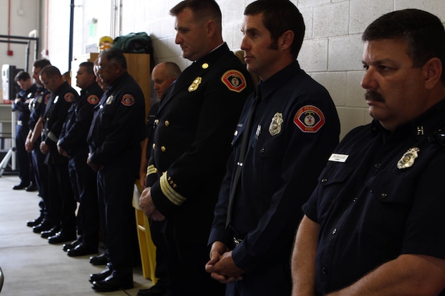 Camp Pendleton Fire Department firefighters show respect by bowing their heads during an invocation given at a dedication ceremony of Pendleton’s Fire Station 10 in honor of Sgt. Brian E. Dunlap here April 6. Dunlap was an advisor for the Iraqi Army and firefighter with the Camp Pendleton Fire Department and in 2005 and was killed by an improvised explosive device while conducting combat operations against enemy forces in Abu Fleiss, Iraq.