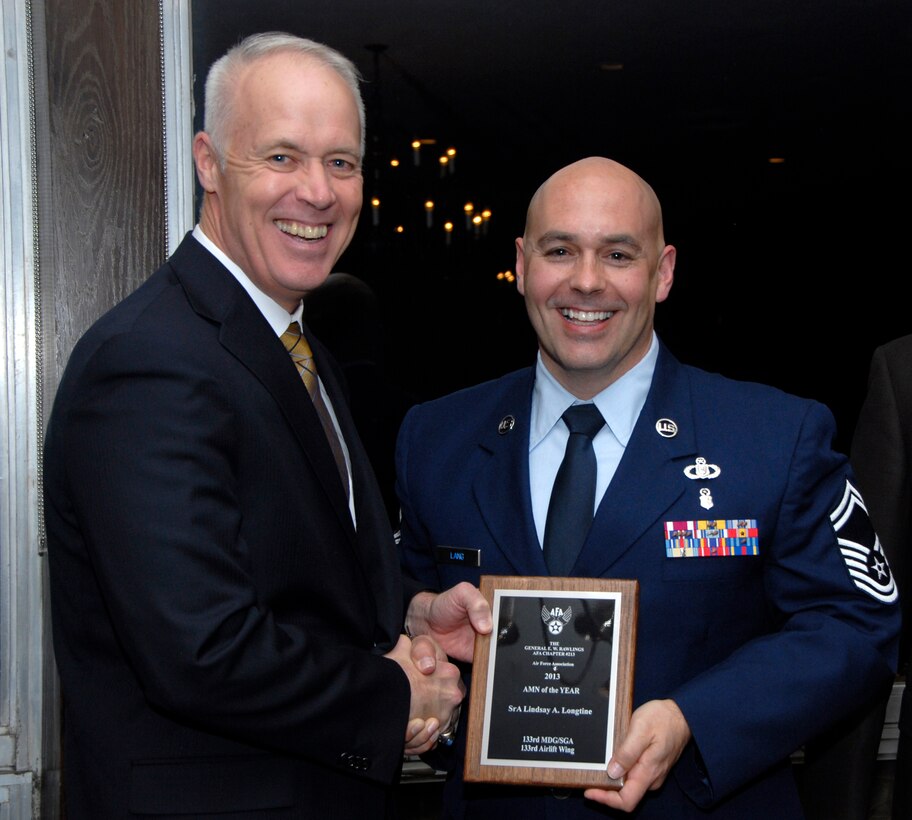 Senior Master Sgt. Duke Lang, 133rd Medical Group, accepts an award for Senior Airman Lindsey Longtine from Retired U.S. Air Force Lt. Gen. Richard Newton, Executive Vice President of the Air Force Association in St. Paul, Minn., Apr. 5, 2013. Longtine is being honored during the Air Force Association’s Annual Awards Dinner for being the 133rd Airlift Wing Outstanding Airman of the Year.
(U.S. Air Force photo by Airman 1st Class Kari Giles /Released)
