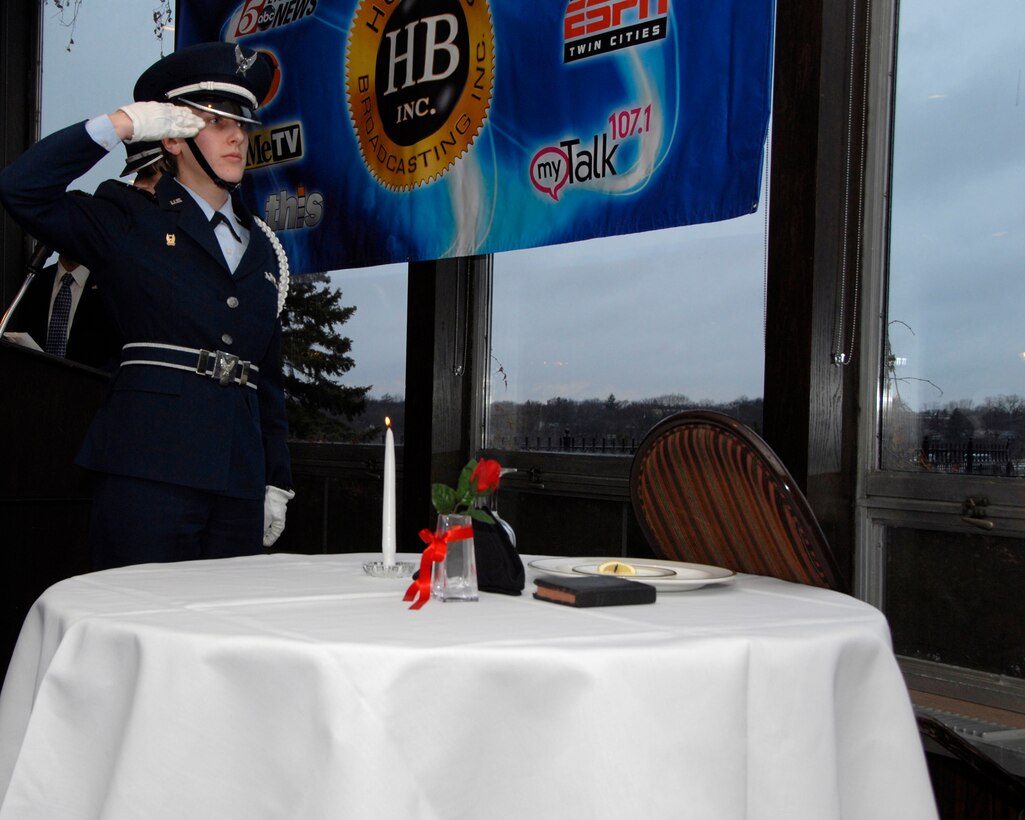 Cadet LeAnne Pratt, University of St. Thomas ROTC Detachment 410, salutes the lit candle glass during The Missing Man Ceremony at the Air Force Association’s Annual Awards Dinner in St. Paul, Minn., Apr. 5, 2013. This candle is reminiscent of the light of hope that lives in our hearts to illuminate their way home, away from their captors, to the open arms of a grateful nation. 
(U.S. Air Force photo by Airman 1st Class Kari Giles/Released)
