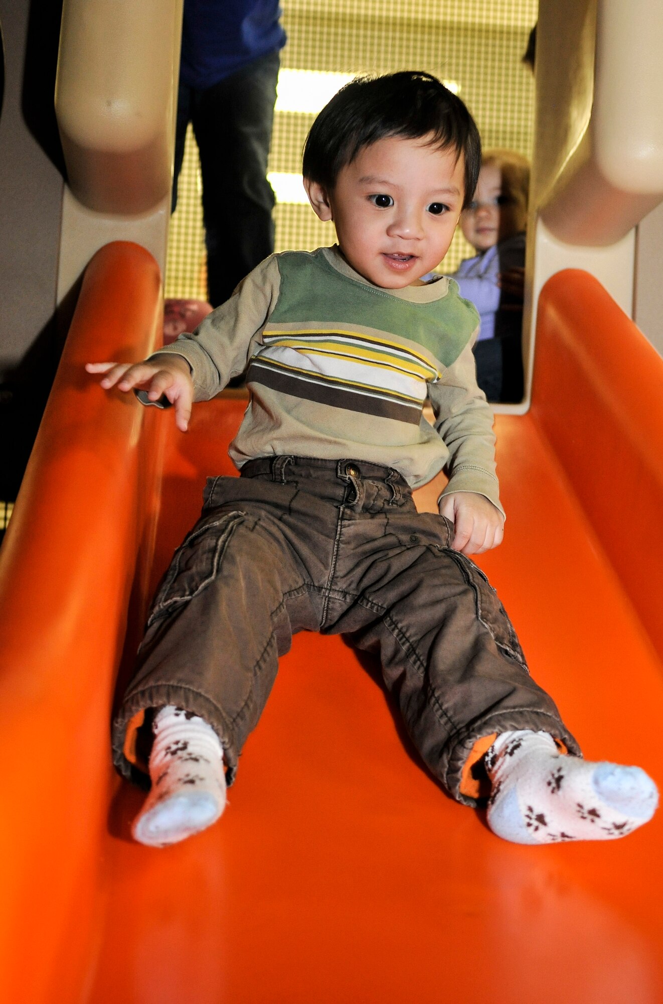 Aiden Rey, son of U.S. Air Force Tech. Sgt. Ronaldo Rey, 354th Logistics Readiness Squadron quality assurance specialist, tests a new slide during Eielson City Center’s opening March 29, 2013, Eielson Air Force Base, Alaska. The ECC is centrally located on base, giving Airmen easy access to various indoor activities to help through the winter months. (U.S. Air Force photo/Senior Airman Racheal E. Watson/Released)