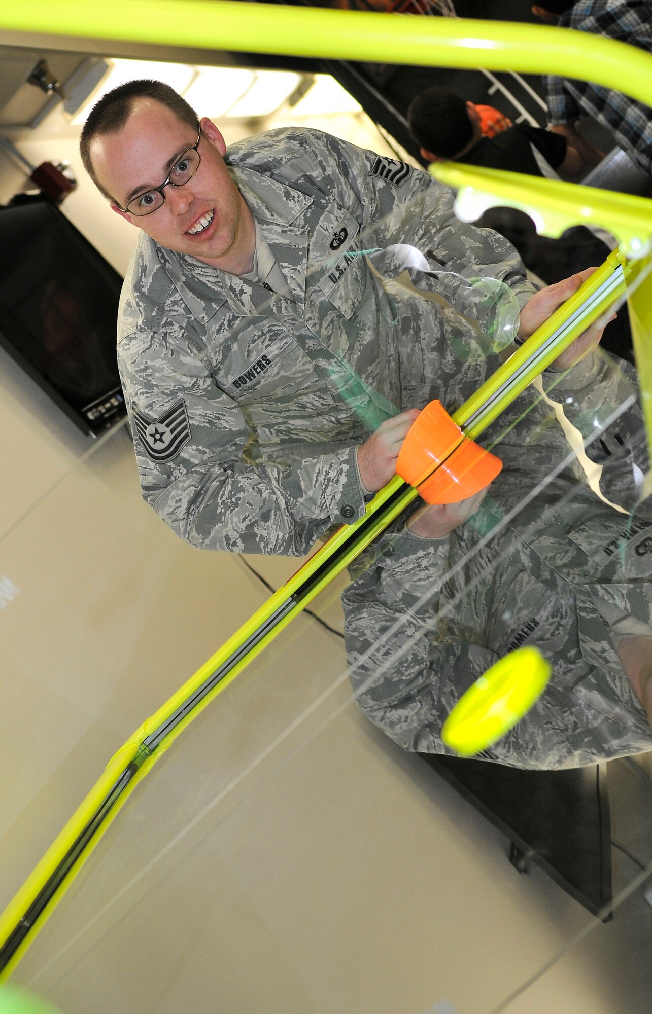 U.S. Air Force Tech. Sgt. Shawn Bowers, 354th Operations Support Squadron air traffic controller, plays air hockey during Eielson City Center’s opening March 29, 2013, Eielson Air Force Base, Alaska. The ECC provides a variety of activities, including foosball, golf, basketball and a bouncy house. (U.S. Air Force photo/ Senior Airman Racheal E. Watson/Released)