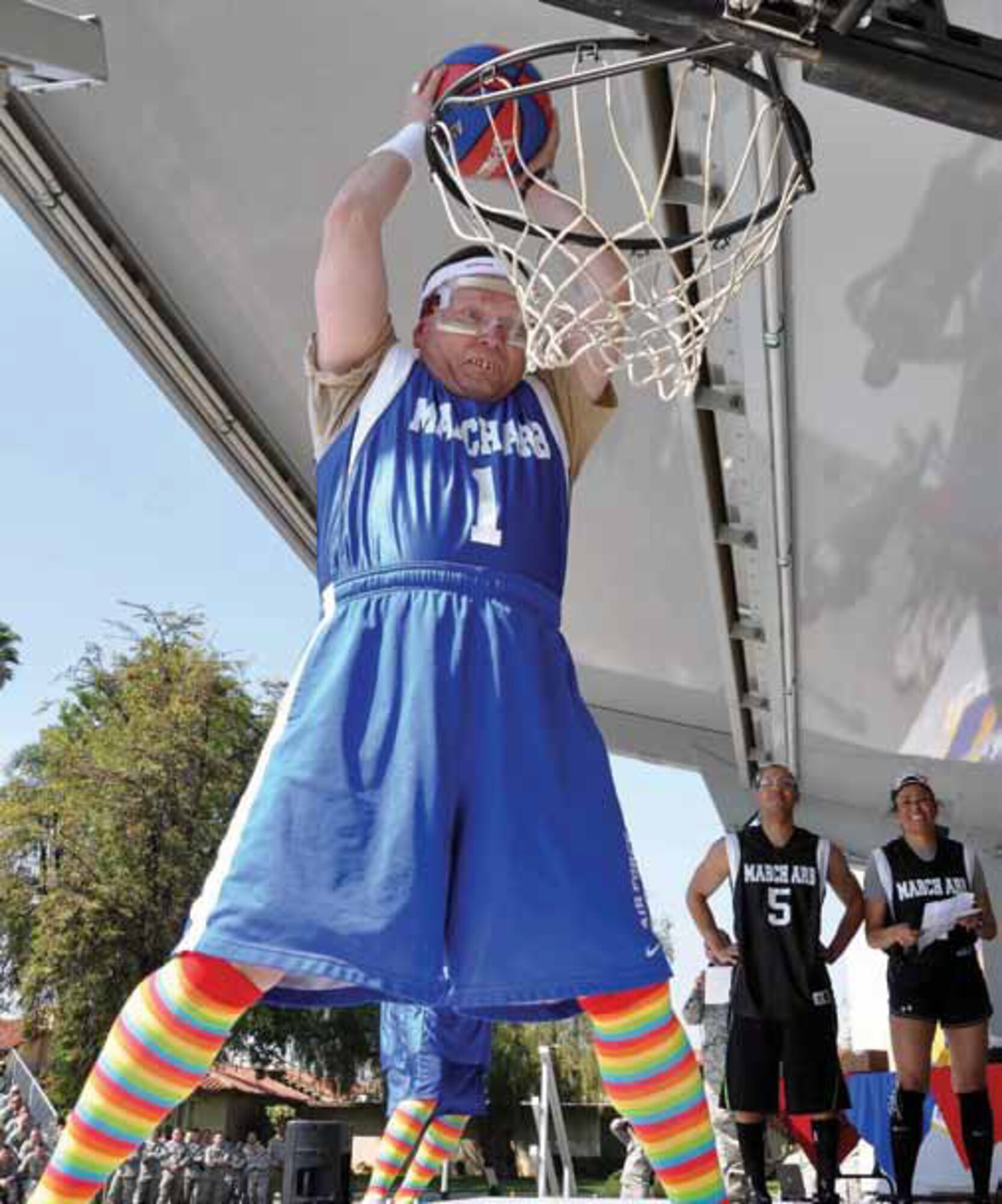 The 452d Air Mobility Wing leadership used an unconventional commander's call to recognize teams and individuals on their performance during the Operational Readiness and Nuclear Operational Readiness Inspections. Col. Samuel Mahaney (pictured), commander; Col. James Finney, vice commander; and Chief Master Sgt. Ericka Kelly, command chief, beat the unofficial Air Mobility Command Inspector General basketball team to represent the wing's recent, successful completion of both inspections. (U.S. Air Force photos by Master Sgt. Linda Welz)