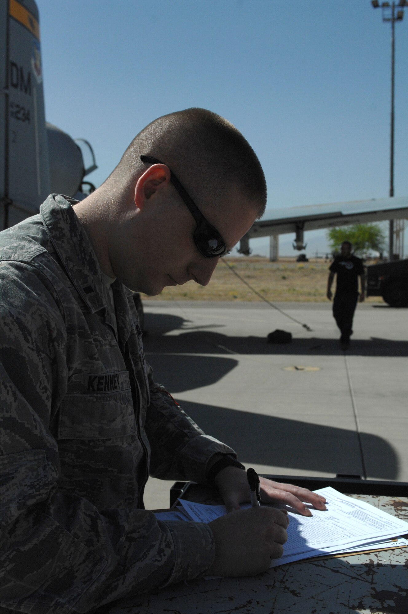 U.S. Air Force 1st Lt. Daniel P. Kenney, 355th Fighter Wing A-10 Divestiture Team officer in charge, signs paperwork at the 309th Aerospace Maintenance and Regeneration Group at Davis-Monthan Air Force Base, Ariz., April 8, 2013. Kenney signed over two A-10s to be placed into retirement. (U.S. Air Force photo by Airman 1st Class Betty R. Chevalier/released)